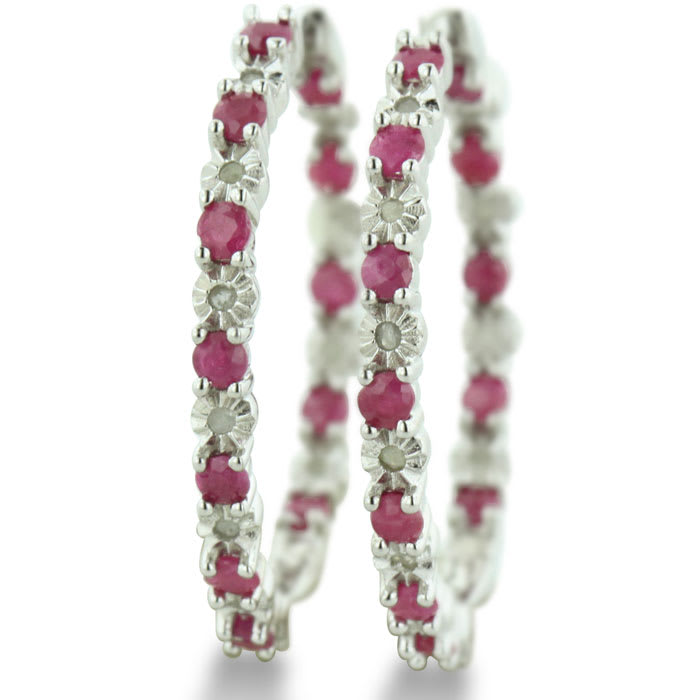 Hoop earrings will always be in style!  Be sure to grab these fabulous ruby and diamond hoop earrings.  Each earring has 12 ruby stones and are set in sterling silver.  Dangling at about 1 inches down, they are perfect for everyone.  Total gem weight is 1.5 carats.  Diamond content is .01 carats, diamond color is J-K and diamond clarity is I2-I3.