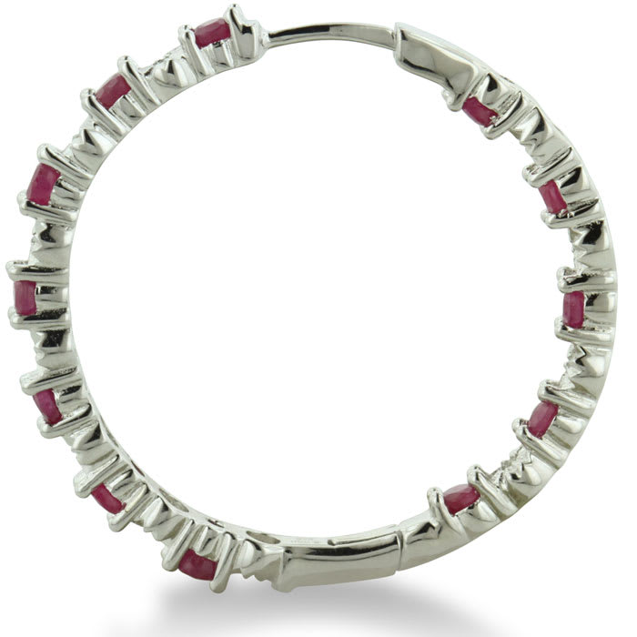 Hoop earrings will always be in style!  Be sure to grab these fabulous ruby and diamond hoop earrings.  Each earring has 12 ruby stones and are set in sterling silver.  Dangling at about 1 inches down, they are perfect for everyone.  Total gem weight is 1.5 carats.  Diamond content is .01 carats, diamond color is J-K and diamond clarity is I2-I3.