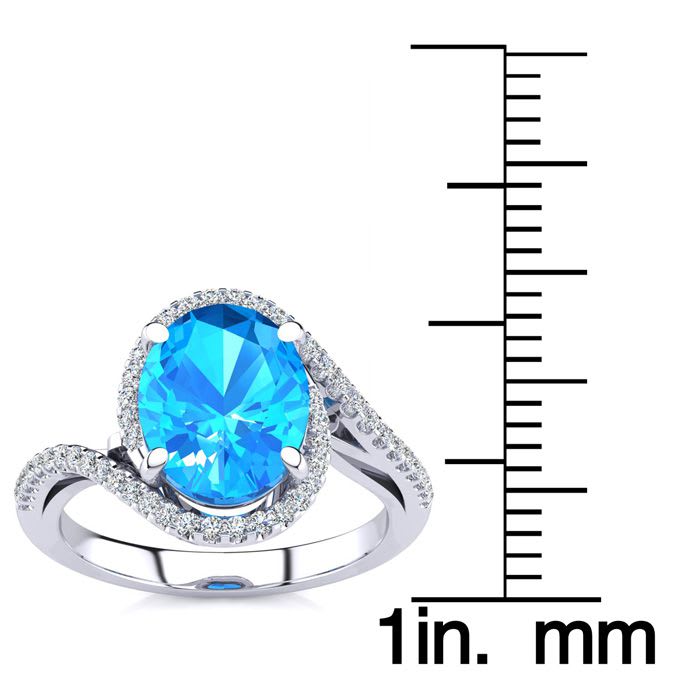3 1/2 Carat Oval Shape Blue Topaz and Halo Diamond Ring In 14 Karat White Gold