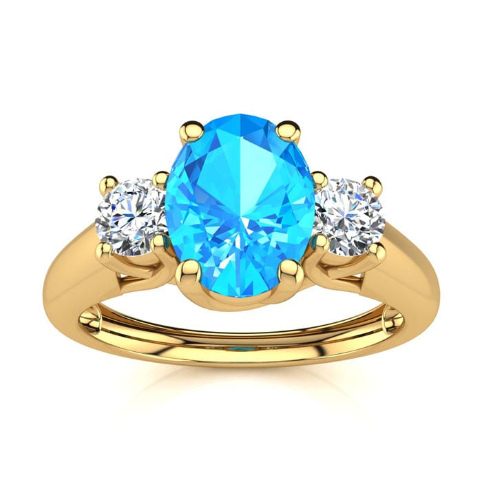 1 1/5 Carat Oval Shape Blue Topaz and Two Diamond Ring In 14 Karat Yellow Gold
