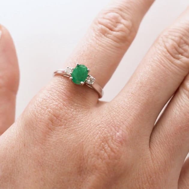 1 Carat Oval Shape Emerald and Two Diamond Ring In 14 Karat White Gold