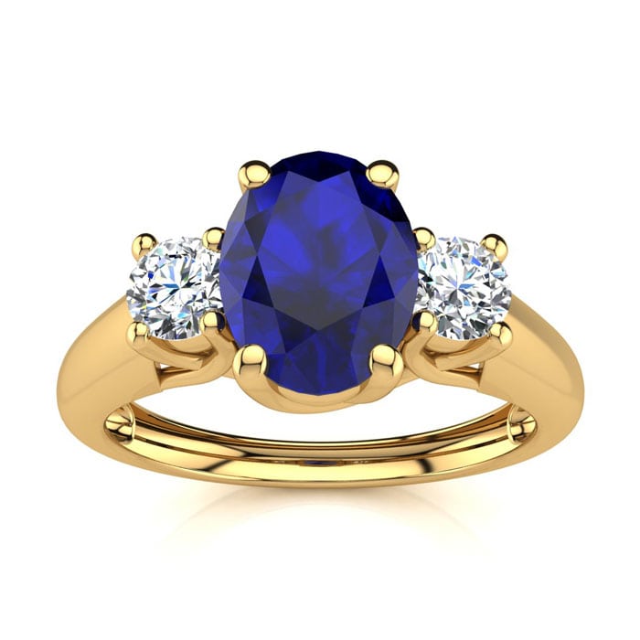 1 1/5 Carat Oval Shape Sapphire and Two Diamond Ring In 14 Karat Yellow Gold