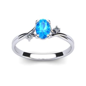 1/2 Carat Oval Shape Blue Topaz and Two Diamond Accent Ring In 14 Karat White Gold