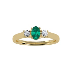 1/2 Carat Oval Shape Emerald and Two Diamond Ring In 14 Karat Yellow Gold