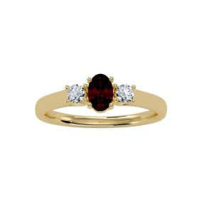 3/4 Carat Oval Shape Garnet and Two Diamond Ring In 14 Karat Yellow Gold