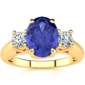 1 1/2 Carat Oval Shape Tanzanite and Two Diamond Ring In 14 Karat Yellow Gold