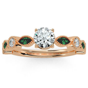 1 1/4 Carat Round and Marquise Vintage Diamond and Emerald Engagement Ring In 14 Karat Rose Gold