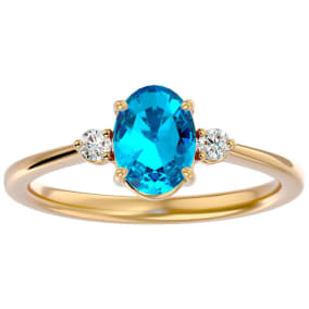 1 1/2 Carat Oval Shape Blue Topaz and Two Diamond Ring In 14 Karat Yellow Gold