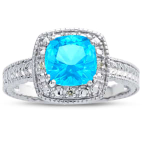 Blue Topaz Ring: 1 1/4 Carat Cushion Cut Blue Topaz and Halo Diamond Ring In Sterling Silver