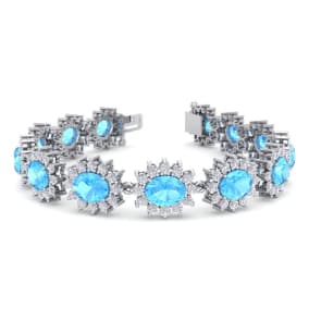 24 Carat Oval Shape Blue Topaz and Halo Diamond Bracelet In 14 Karat White Gold, 7 Inches