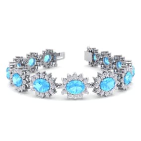 Retrograde Birthstones™ 24 Carat Oval Shape Blue Topaz and Halo Diamond Bracelet In 14 Karat White Gold, 7 Inches